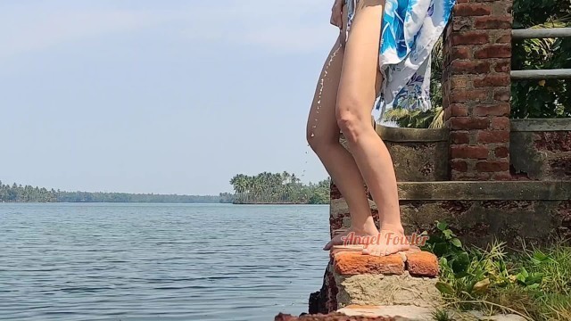 Shameless Tourist Girl Pissing on the Public Waterfront taking off her Swimsuit.