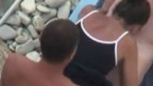 Two men fuck a woman on beach